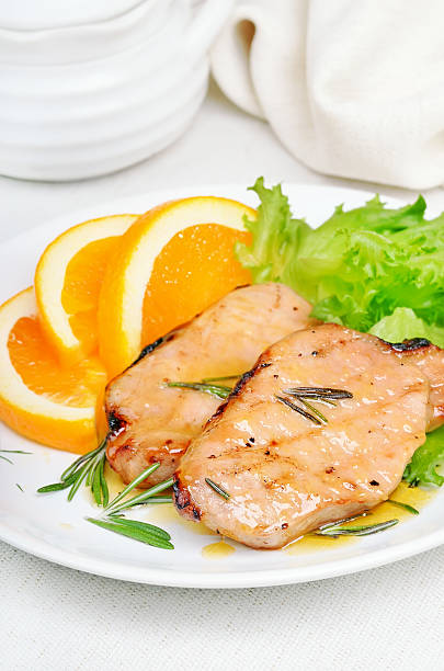 istock Baked pork chop with orange sauce 470454788