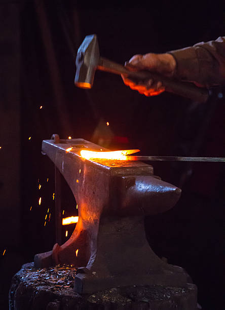 istock Blacksmith hammering a hot metal rod 470455108