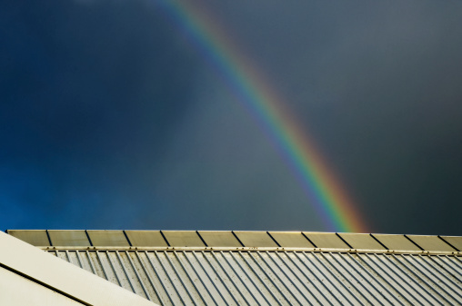 rainbow over roof of building