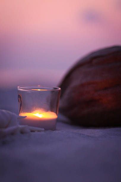 istock tropical Candle and Coconut Scene on the Beach 470463238