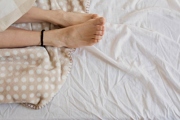 istock girl with wool socks, sleeping in bed 470463468