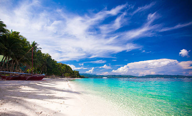 istock Tropical beach with white sand and a small boat 470470079