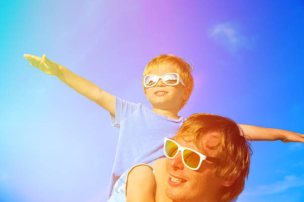 istock Father and little son playing on summer sky 470470568