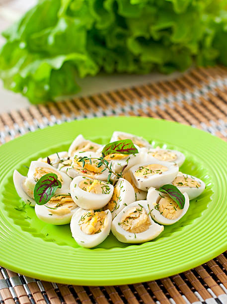 istock Boiled quail eggs halves on a green plate 470470680