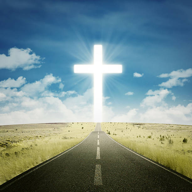 Empty highway with a cross Empty road toward the heaven with a cross on the end of the road spiritual highway stock pictures, royalty-free photos & images