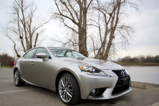 Sacramento, California, USA, - February 15, 2014: The Lexus IS250 introduces a new body style in 2014. Pictured here in Atomic Silver parked along the Sacramento River.