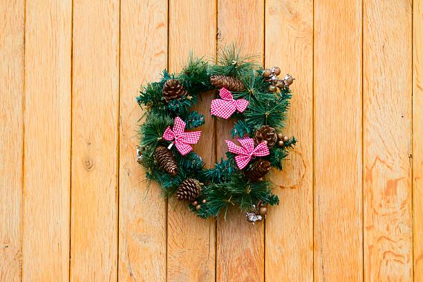 istock Christmas wreath with fir cones on a wooden wall 470477621