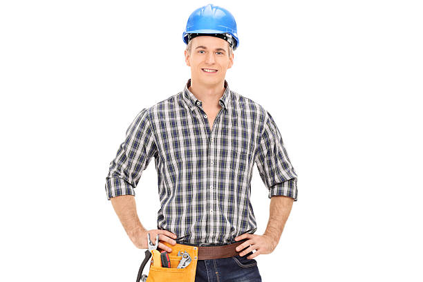 istock Confident construction guy in uniform wearing helmet and posing 470479126