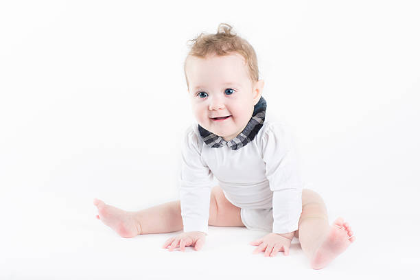 istock Funny baby girl sitting with a white background 470487589