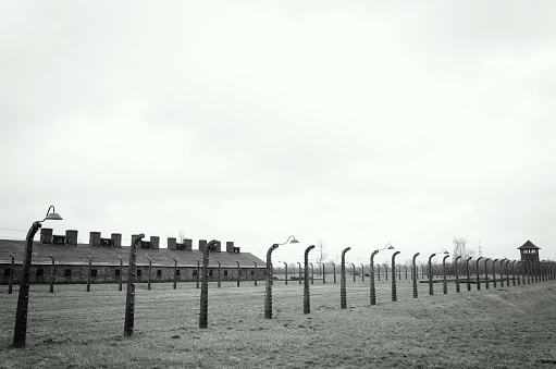 Oswiecim, Poland - April 3, 2015: The Auschwitz concentration camp is located about 50 km from Krakow. The picture shows lamps and electrical fence that surrounds the camp Auschwitz II Birkenau in Poland. 
