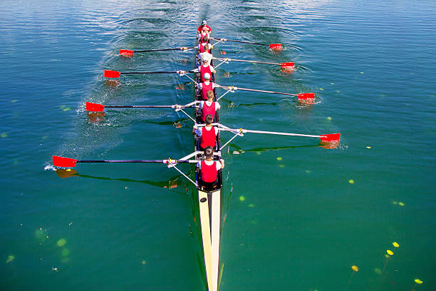 Boat coxed eight Rowers rowing Zagreb, Croatia - September 21, 2014: Young athletes train rowing on the Lake Jarun rowing stock pictures, royalty-free photos & images