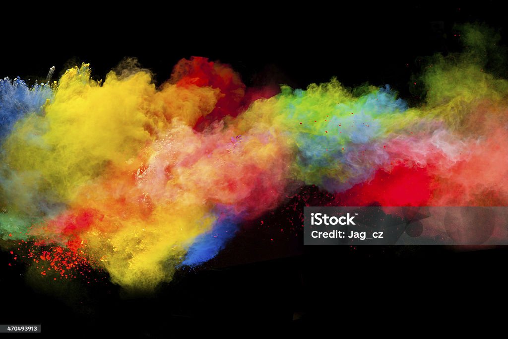 colored dust Freeze motion of colored dust explosion isolated on black background Exploding Stock Photo