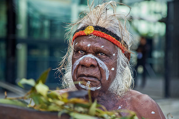 Australian aborigine performs a smoking ceremony Sydney,Australia - April 12,2015: Aboriginal elder Uncle Max Eulo performs a smoking ceremony at an urban regeneration event in White Bay. He has also performed for the pope and Oprah Winfrey. indegious culture stock pictures, royalty-free photos & images