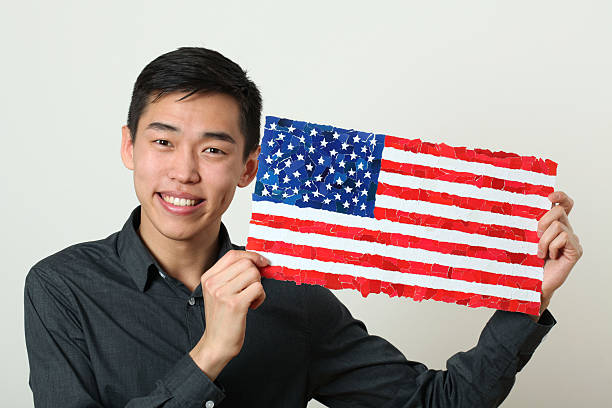 istock Young Asian student showing US national flag 470506710