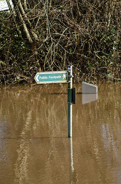 istock Floods - footpath sign surrounded by water 470508577