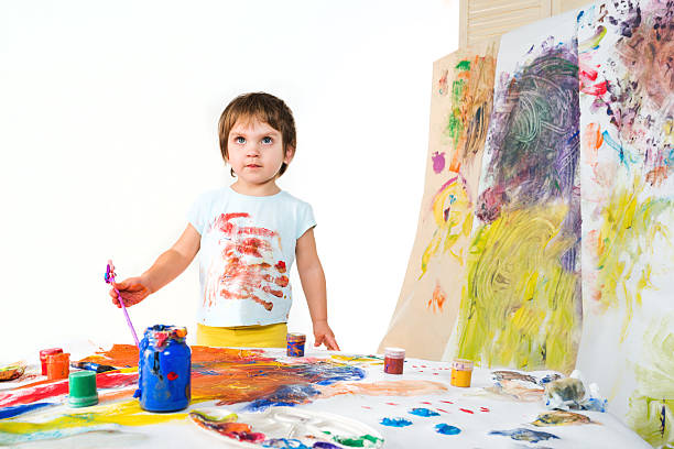 istock Small child draw paints on a paper wall 470509450