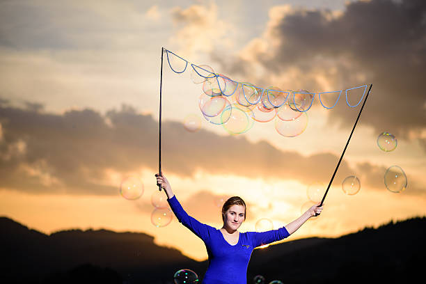 istock soap bubble artist in sunset 470509604