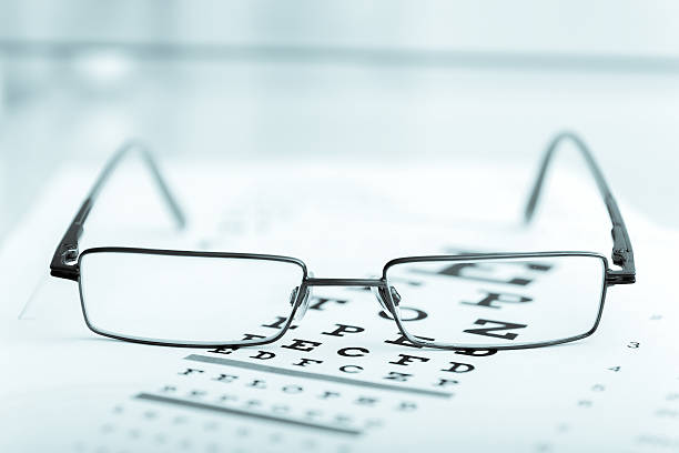 istock Clear Black modern glasses on a eye sight test chart 470509746