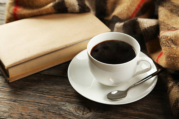 istock Cup of coffee with plaid and book 470509922