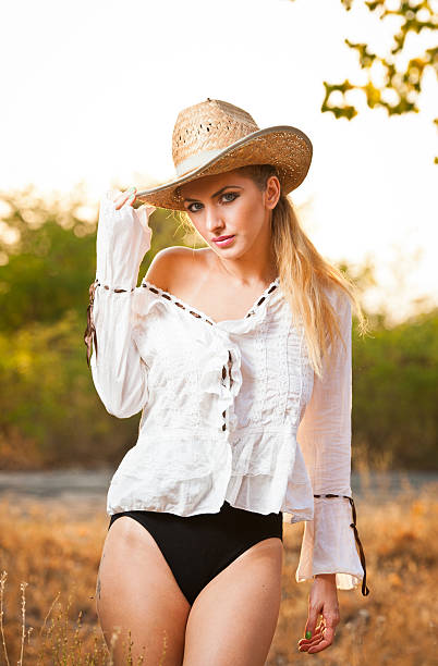 istock Attractive blonde girl with straw hat and white blouse 470510639