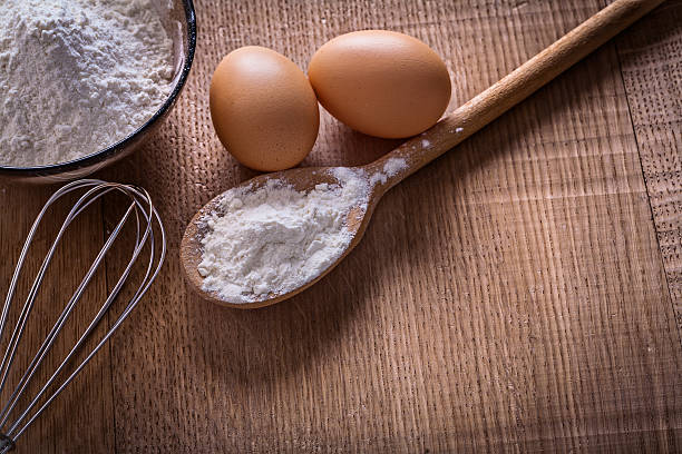 istock spoon bowl with flour eggs corolla on wooden board food 470513198