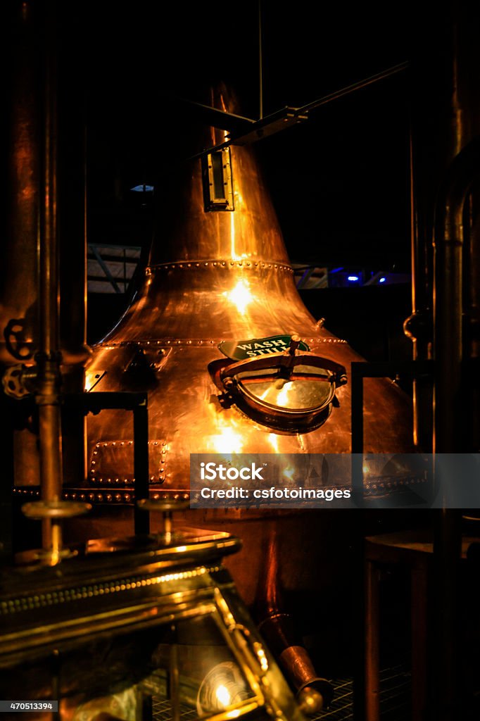 Copper metal vat in a dark distillery Dublin, Eire - November 18, 2013: Copper fermentation vats at an Irish Whiskey distillery Distillery Still Stock Photo