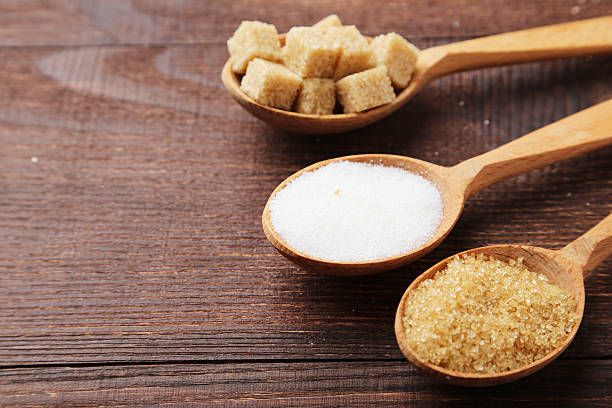 istock Various kinds of sugar in spoons on brown wooden background 470514404