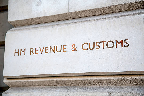 HM Revenue & Customs Sign, Westminster, London HM Revenue & Customs sign incised into the wall outside their headquarters in Whitehall, City of Westminster, London hm government stock pictures, royalty-free photos & images