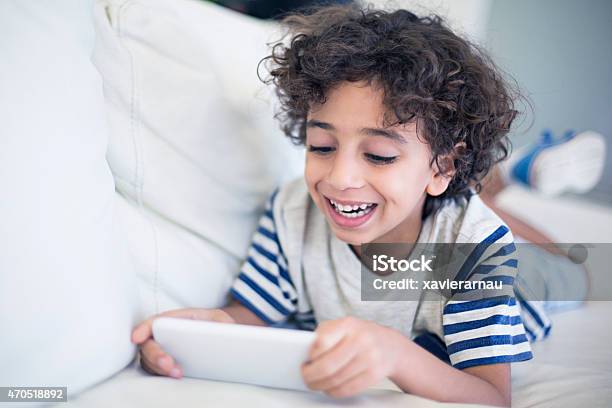 Happy Kid Playing With The Mobile Phone Stock Photo - Download Image Now - Boys, Happiness, Middle Eastern Ethnicity