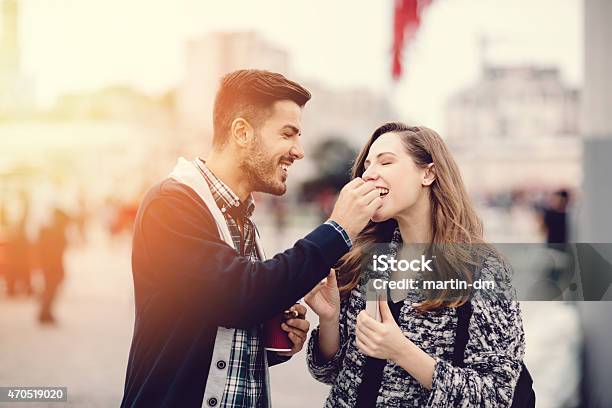 Young Couple In The City Eating Chestnuts Stock Photo - Download Image Now - Eating, Chestnut - Food, Couple - Relationship