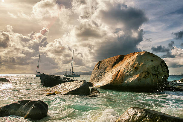 Dramatic shot from The Baths in Virgin Gorda with giant boulders in the foreground, dramatic waves,