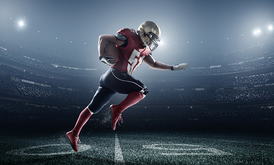 A male american football player makes a dramatic play. The stadium is blurred behind him.  The player is wearing generic unbranded american football uniform. The stadium is 3D rendered.