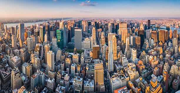 New York aerial panorama over iconic Manhattan skyscrapers at sunset Warm late afternoon sunlight illuminating the crowed city blocks and soaring spires of Midtown Manhattan, TImes Square and 5th Avenue, New York. ProPhoto RGB profile for maximum color fidelity and gamut. upper east side manhattan stock pictures, royalty-free photos & images