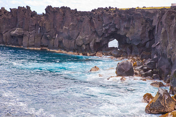 Cap Mechant with giant peebles beach, black volcanic rocks eroded by sea strenght.