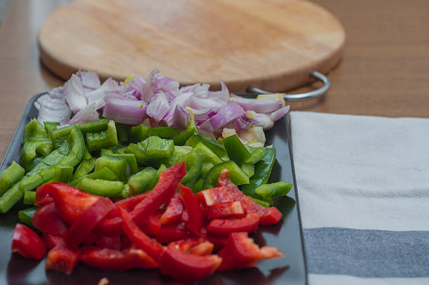 istock Sliced green and red peppers and onion 470524072