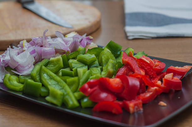 istock Sliced green and red peppers and onion 470524082