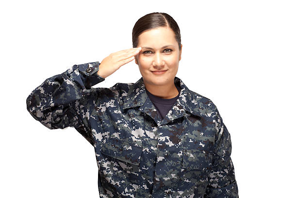 istock Smiling female navy officer saluting 470524154