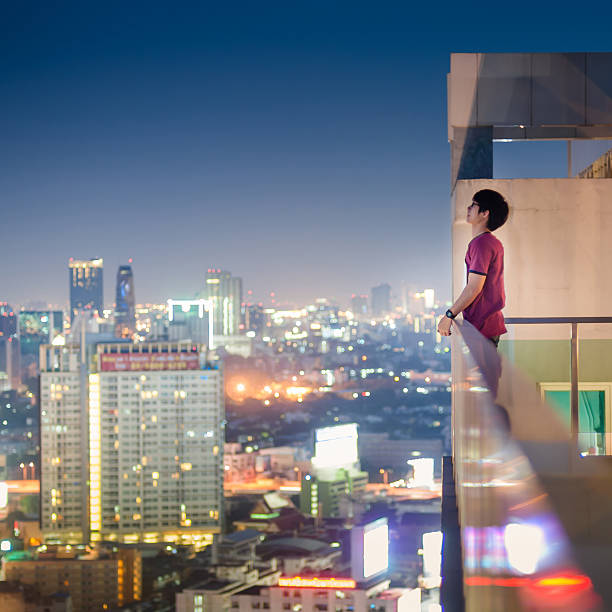 istock Men standing on the rooftop of a skyscraper over  cityscape 470524778