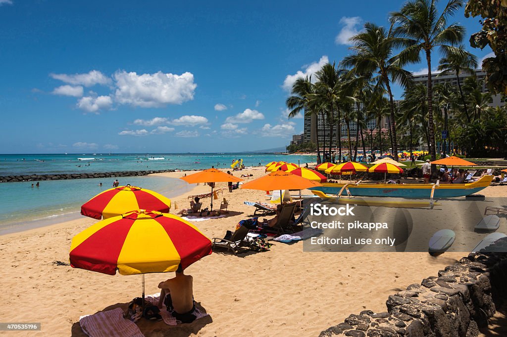 Waikiki Beach, Oahu, Hawaii Waikiki,Oahu,Hawaii,USA - May 29, 2014 : View of the most important beach in Waikiki with its red yellow beach umbrella 2015 Stock Photo