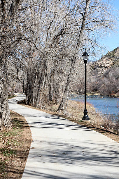 istock Animas River trail surrounded by bare trees and street lamp 470535696