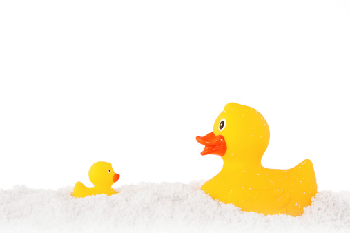 Two yellow rubber ducks in a snow