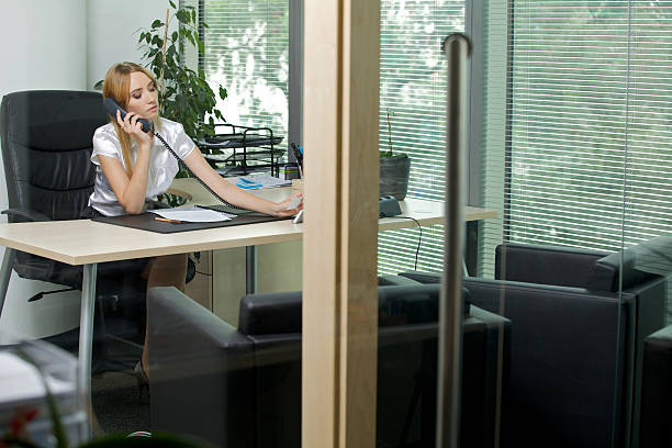 istock Businesswoman using phone at office 470544168