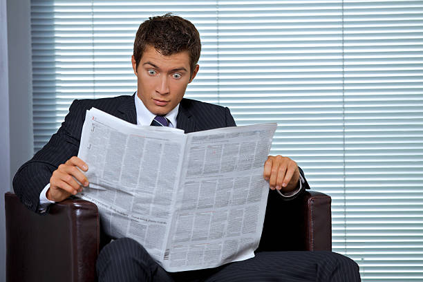 istock Businessman reading newspaper in office 470546574