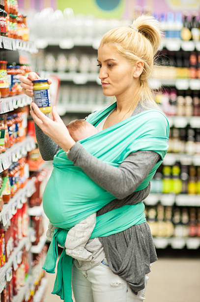 istock Mother shopping holding a baby 470546721