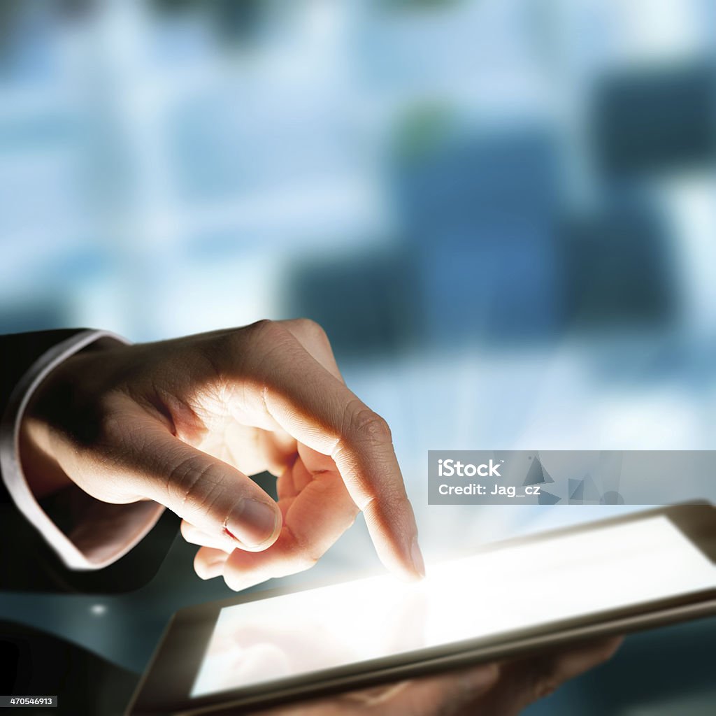 Man hand touching the screen Business concept with man hand touching tablet computer Defocused Stock Photo
