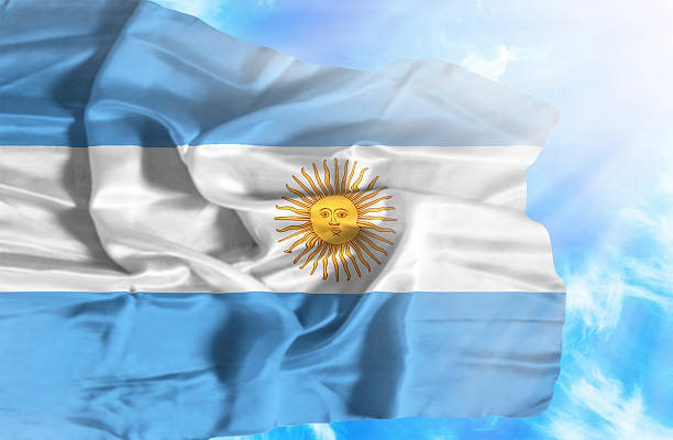 istock Argentina waving flag against blue sky with sunrays 470548283