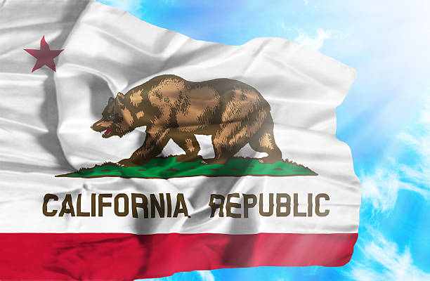 istock California waving flag against blue sky with sunrays 470549303