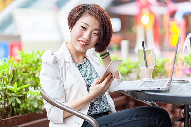 istock young woman using laptop computer in coffee shop. 470551212
