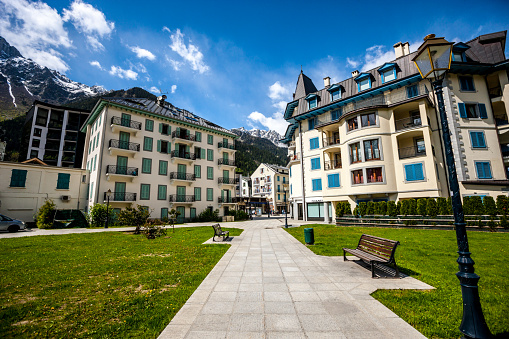 Chamonix-Mont-Blanc, France  - May 15, 2014: Chamonix-Mont-Blanc street with bench, shops, people visible on background
