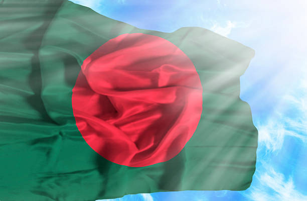 istock Bangladesh waving flag against blue sky with sunrays 470551723